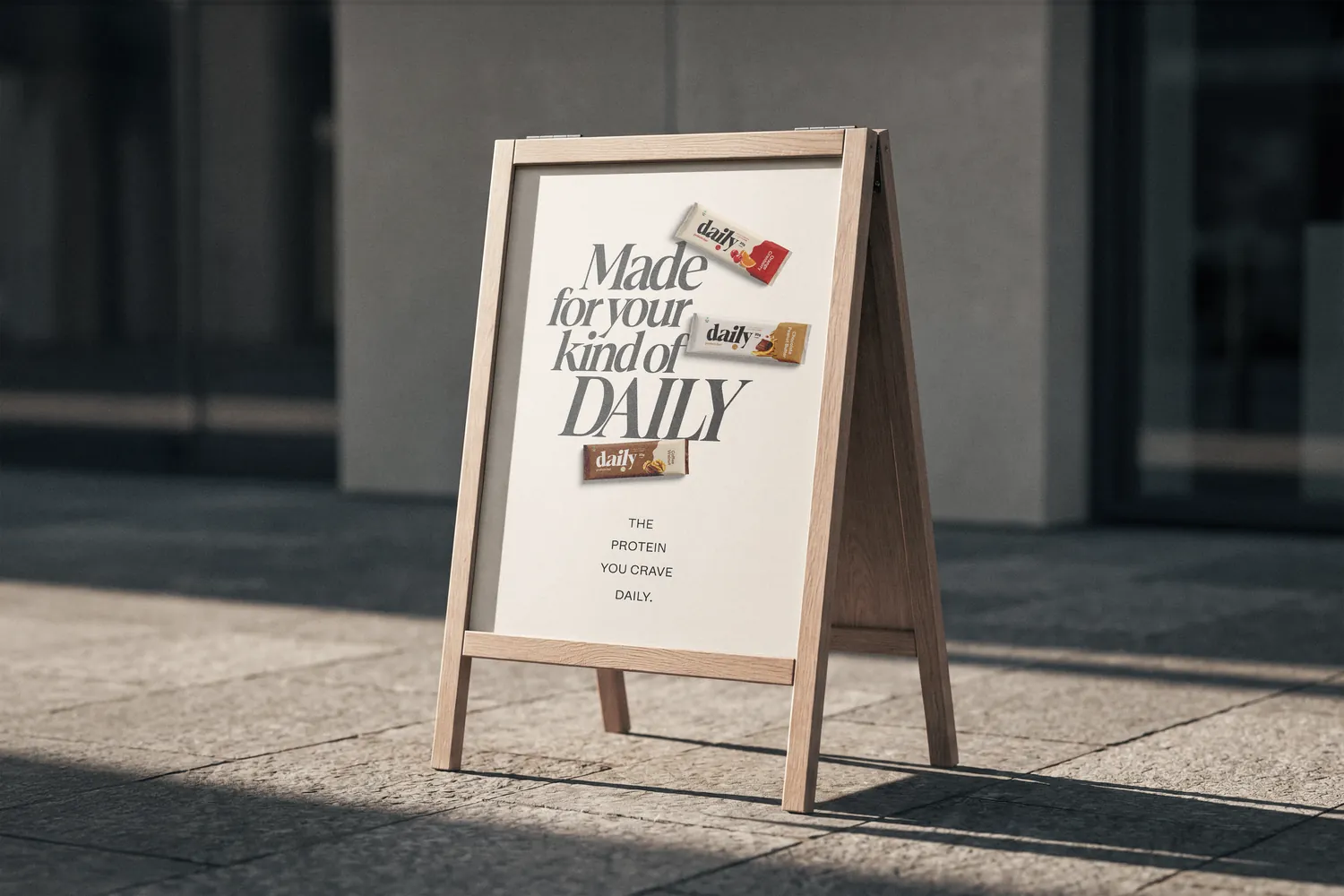 A daily sandwich board on a sunny pavement reading Made for your kind of daily
